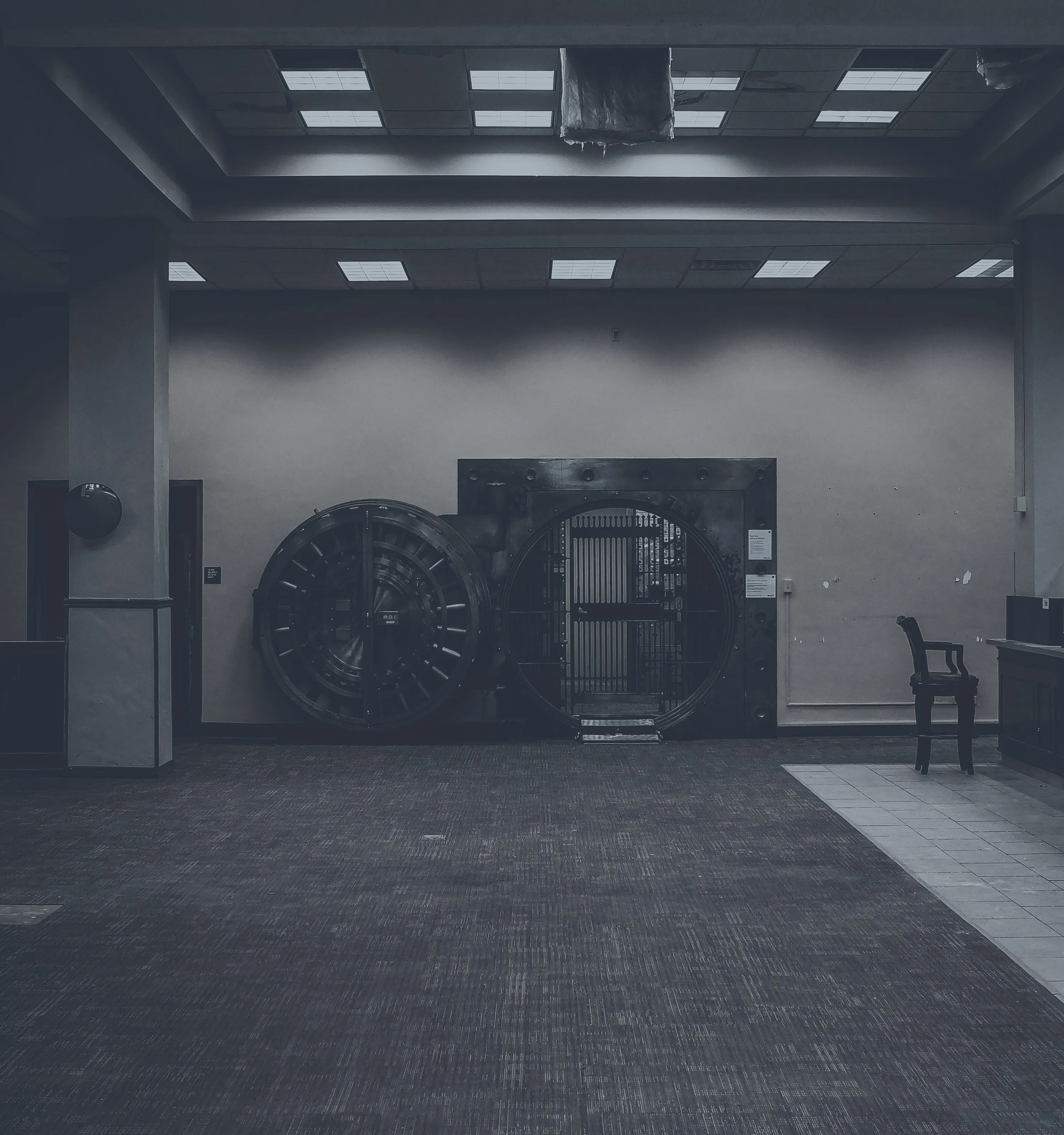 Open bank vault door in a warmly lit room