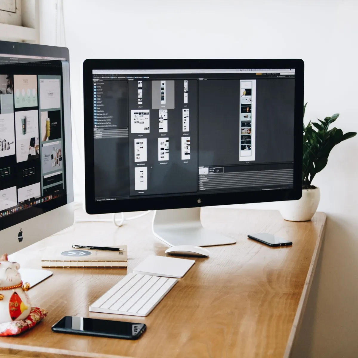Two iMacs on a desk, one showing a website mockup and the other a UI design tool with app screen layouts