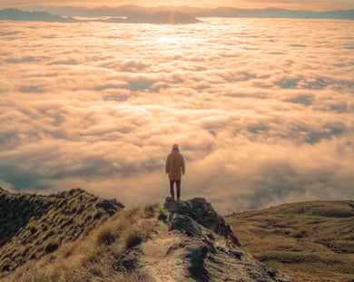Man on peak of mountain