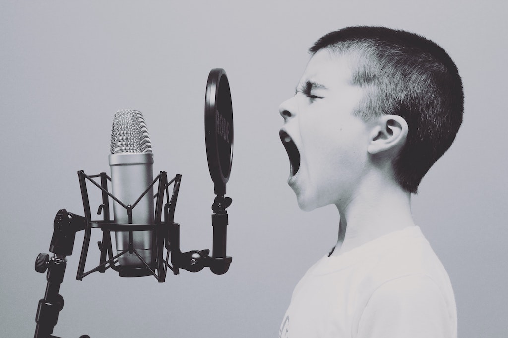 Kid screaming into a microphone